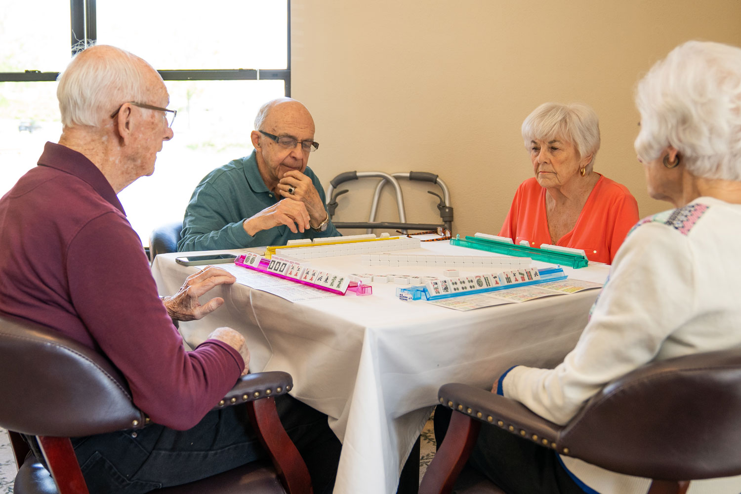 A group of senior residents playing a board game together.