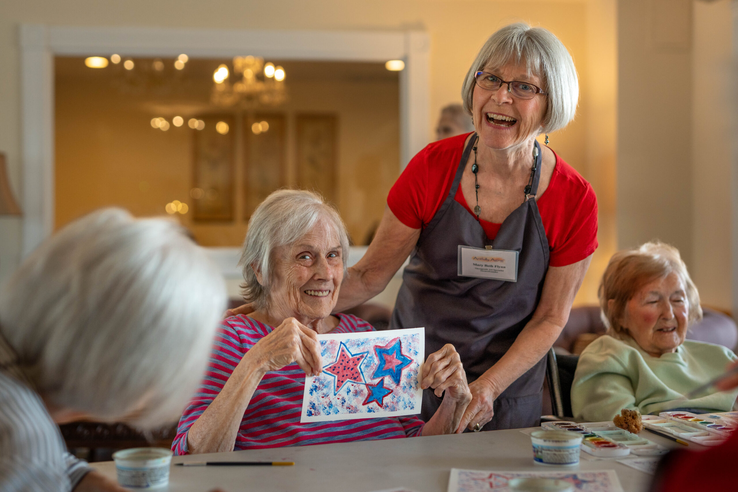 Mari de Villa resident enjoying activities with wellness staff in bright community space