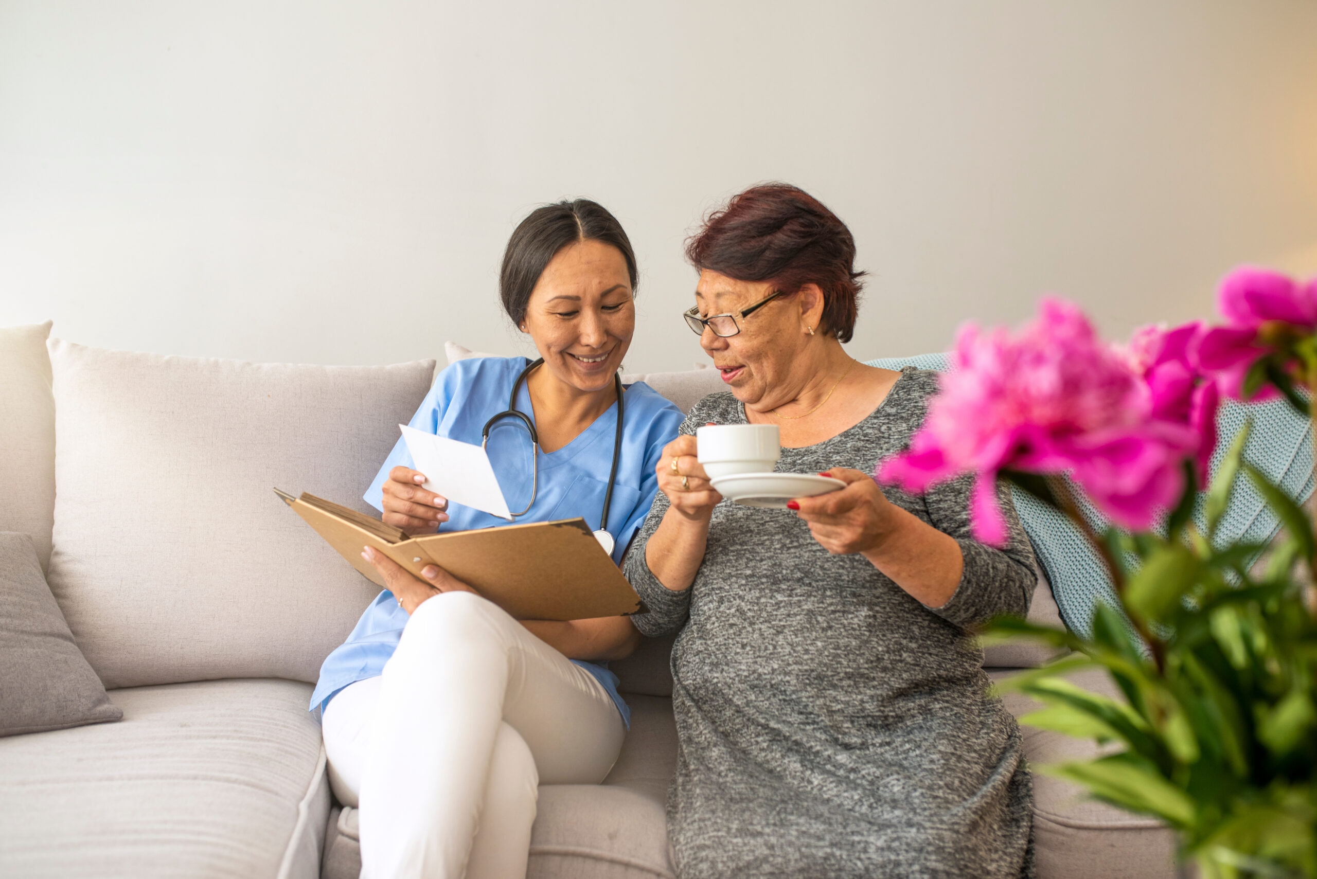 Memory care caregiver reviewing photos with senior resident at St. Louis memory care community