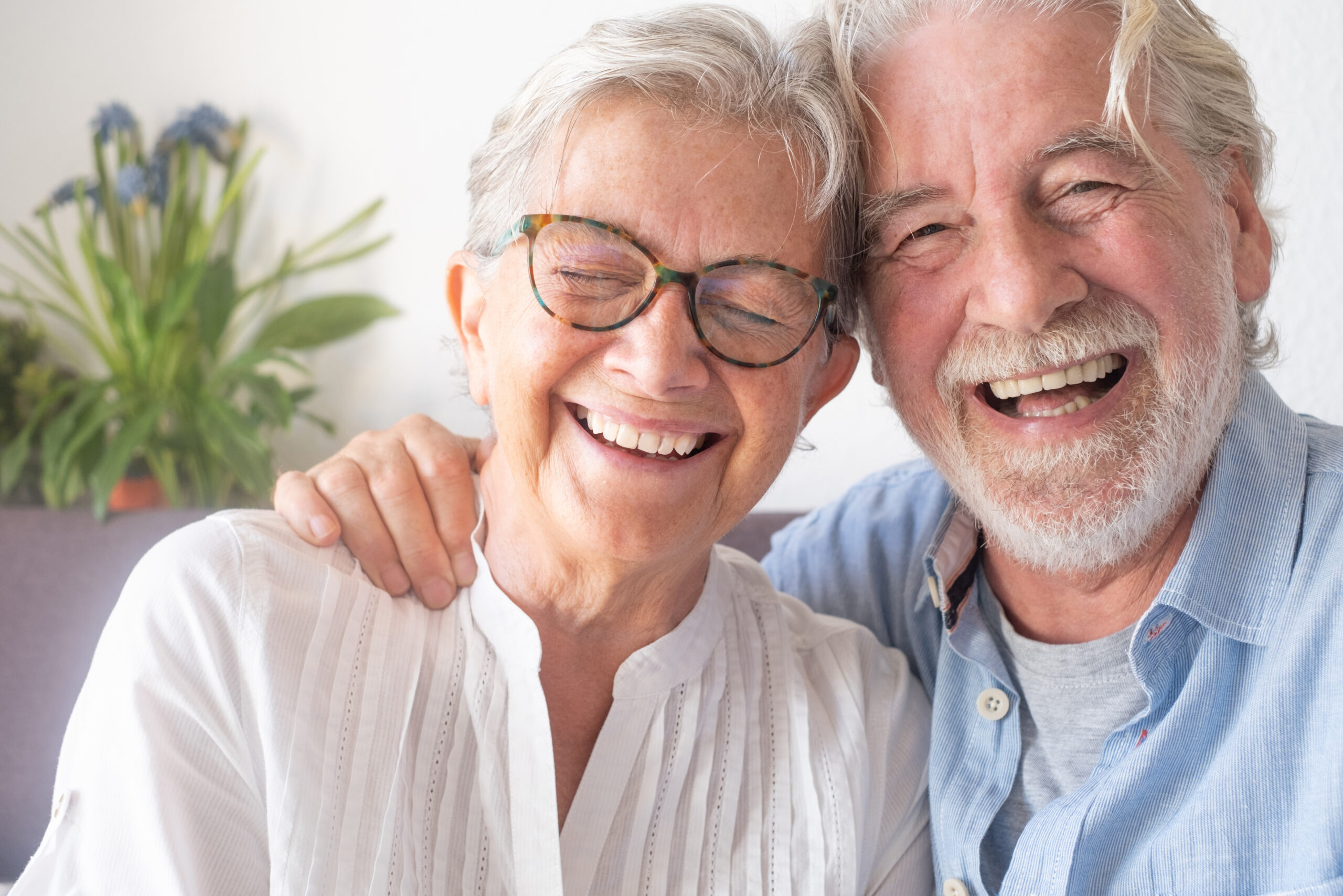 How Purposeful Activities for Dementia Patients Define the Memory Care Experience at Mari de Villa 2 Seniors laughing together at Mari de Villa, a St. Louis senior living community with memory care services.