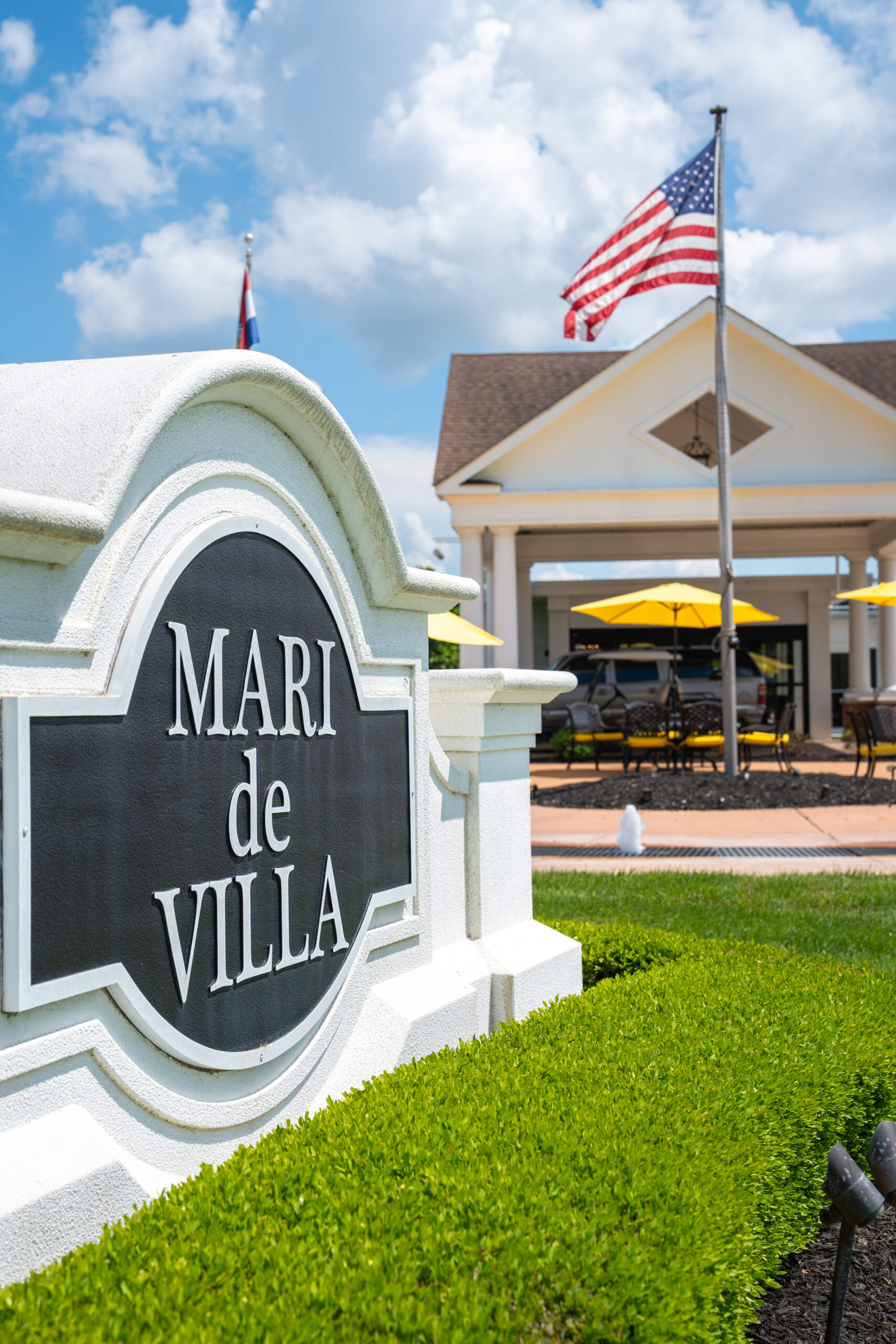 Understanding the Cost of Assisted Living in St. Louis: What Families Actually Need to Know 2 Exterior entrance sign for Mari de Villa assisted living community in St. Louis with manicured grounds and covered patio