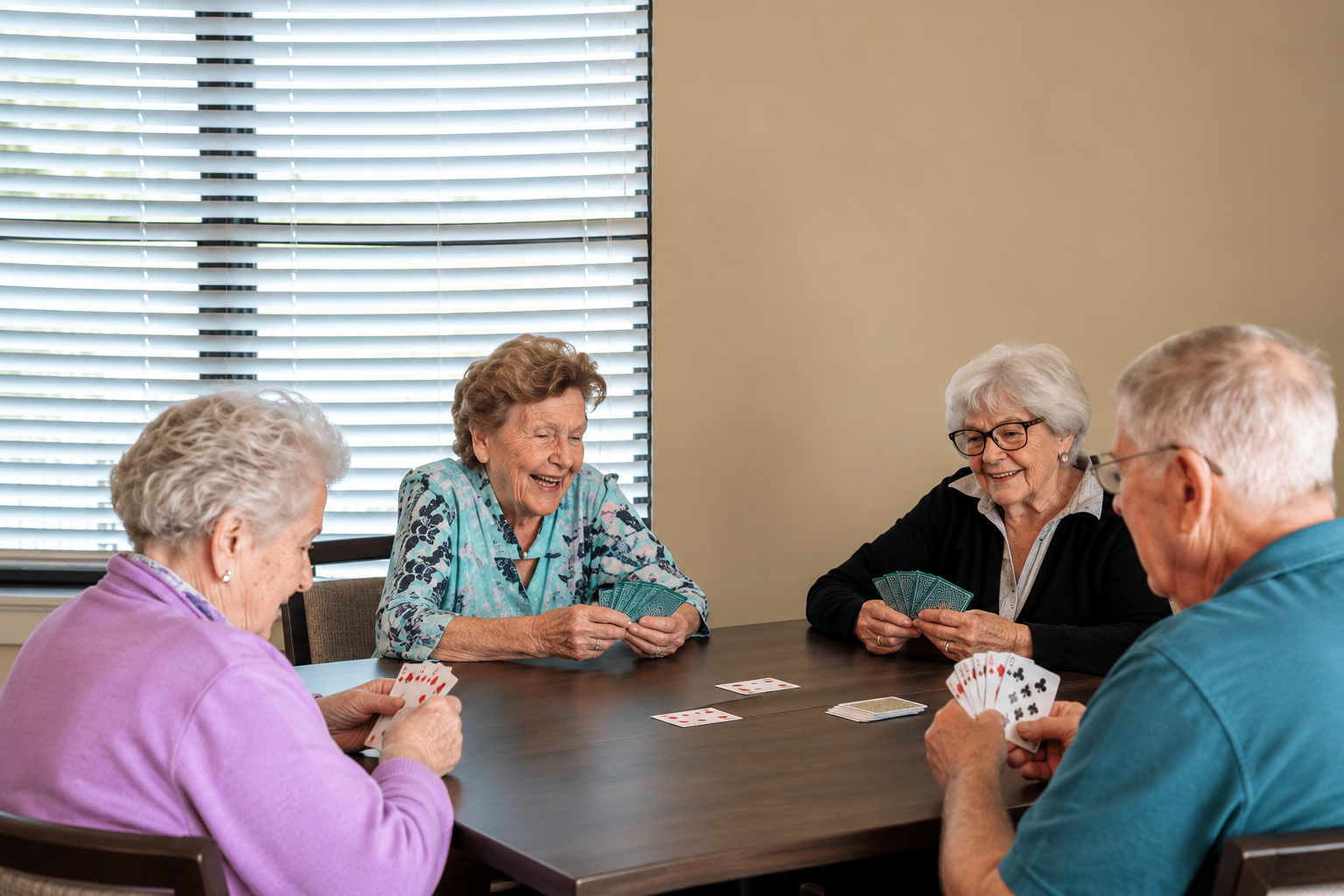 Assisted living residents at Mari de Villa playing cards and socializing together in the community’s activity room